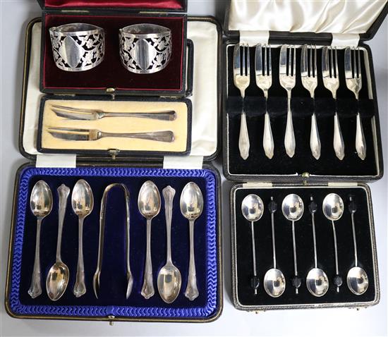 Five cased sets of small silver: a pair of napkin rings, a pair of butter knifes,
